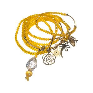 Rubylishious 
Handmade yellow glass bead bracelet with gold charms 
Set of 7 bra
